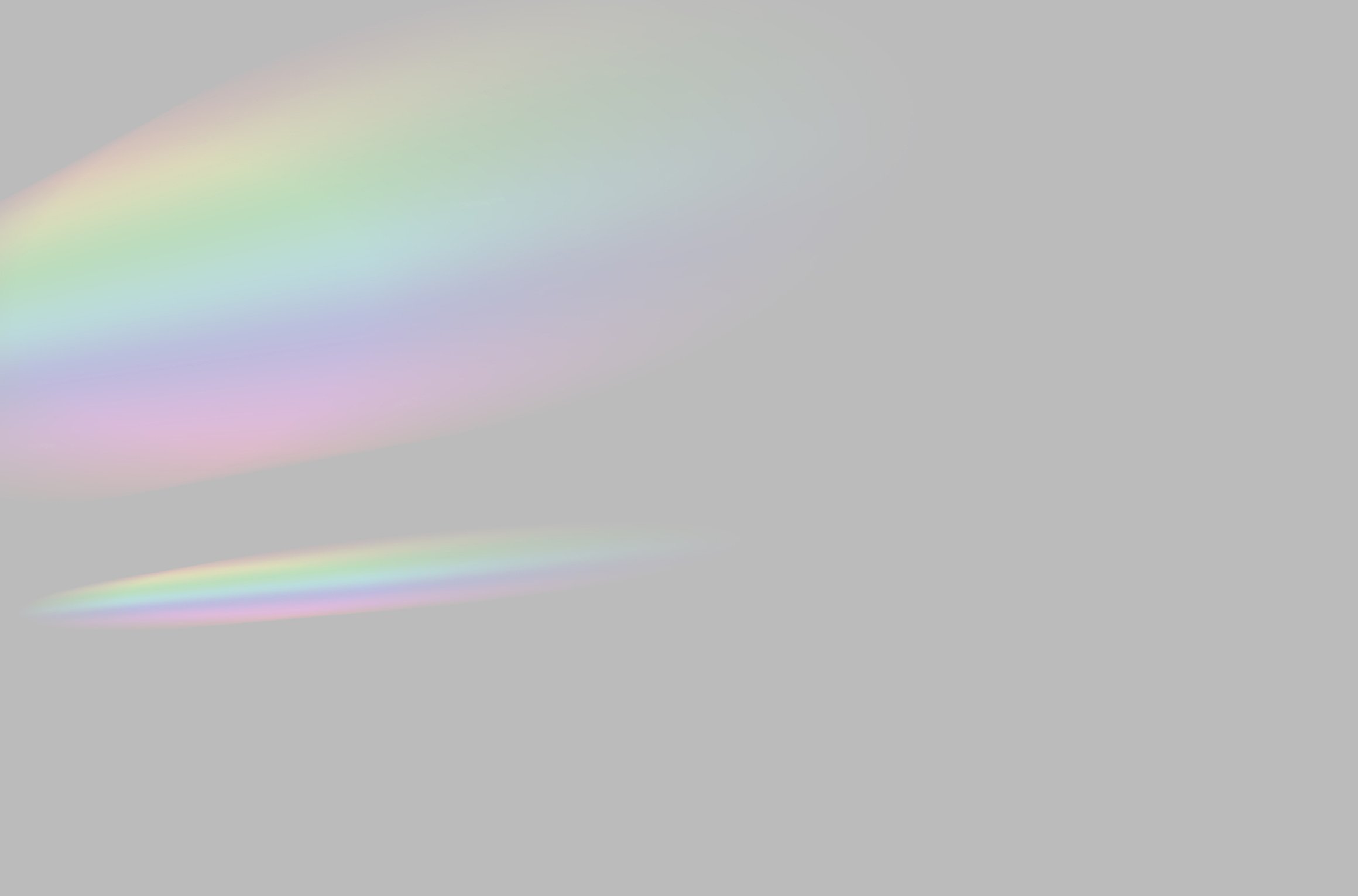 Blurred Rainbow Prism Light Overlay on Grey Background 